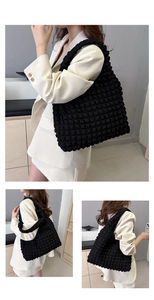 Detail of black bubble texture shoulder bag showing 3D quilted pattern and tote design
