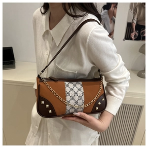 Retro shoulder bag with floral strap detail, golden studs, and metallic chain strap
