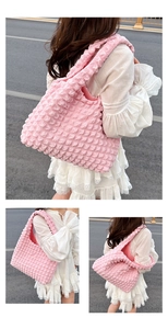 Close-up of pink bubble textured fabric and spacious handle design of the tote bag