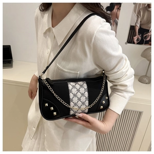 Detail of a retro contrast stitching shoulder bag with gold chain and rivet accents