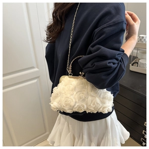 Detail of white 3D rose lace shell bag with vintage gold handle and chain strap