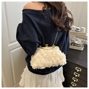 Detail of elegant white 3D rose floral clutch bag with gold chain and vintage metal clasp