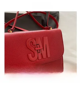 Detail shot of the red lychee leather texture and matching SM metal letter buckle
