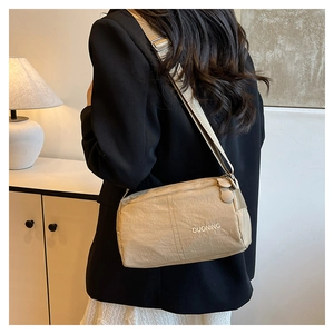 Close-up of lightweight nylon crossbody bag with adjustable strap and DUONING logo