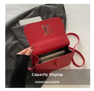 Capacity display of red lychee grain leather square bag showing phone and card wallet inside
