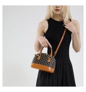 Detail of vintage canvas shell bag with brown leather trim and golden zipper