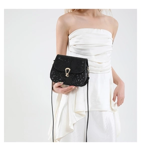 Détail du sac à bandoulière noir à motif serpent avec un fermoir en métal doré unique