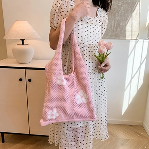 Pink knit tote bag with white flower patterns and woven shoulder strap for summer