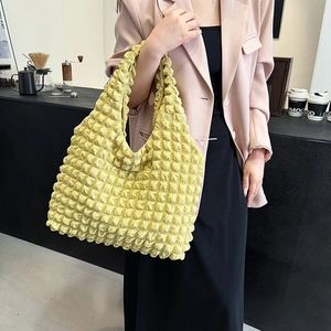 Bright yellow pleated bubble tote bag in textured nylon for 2025 spring summer fashion