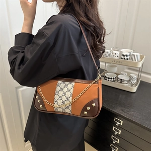 Vintage-style canvas and brown leather underarm bag with contrast print and gold chain