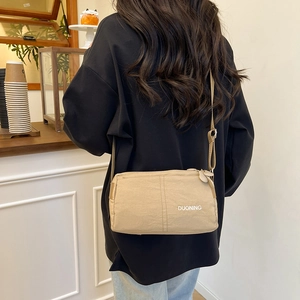 Khaki nylon crossbody bag with DUONING letter print and adjustable shoulder strap