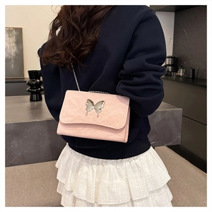 Close-up of pink butterfly chain bag showing texture and silver metallic buckle