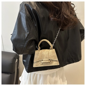 Mini apron-style apricot crossbody bag with a matte texture and silver chain strap details