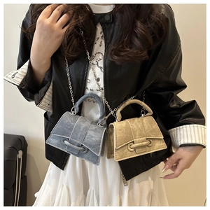 Detail of small crossbody bags with curved base and elegant metal chains in two colors