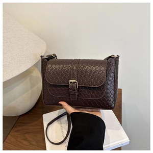 Detail of dark brown woven texture PU leather square crossbody bag with gold buckle