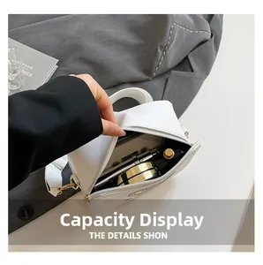 Interior view showing large capacity for lipstick and perfume in white crossbody bag