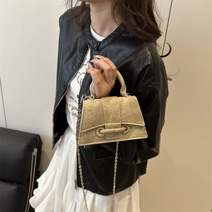 Minimalist tan trapezoid crossbody handbag with metal chain and textured finish