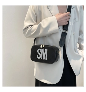 Fashionable black crossbody bag with rhinestone SM letters and a wide shoulder strap