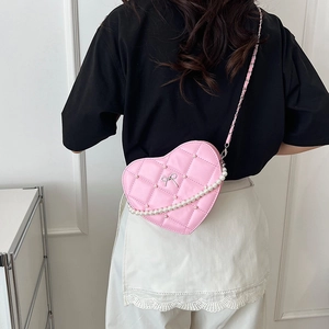 Pink heart-shaped quilted leather crossbody bag with pearl chain and bow decoration