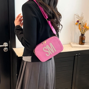 Pink textured small square crossbody bag with sparkling rhinestone SM lettering and wide strap
