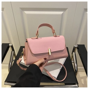 Pink minimalist PU leather handbag featuring a sleek gold rectangular twist-lock closure