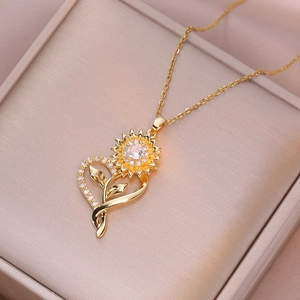 Golden sunflower heart pendant necklace with shimmering zircon stones on cream box