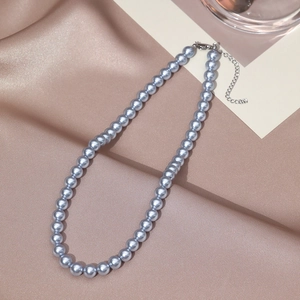 Elegant silver grey pearl necklace with lobster clasp on luxury champagne silk fabric