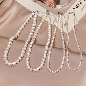 Elegant pearl necklaces in four sizes on silk background with adjustable silver clasp detail