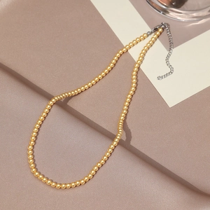 Detail of elegant yellow pearl necklace with silver lobster clasp and extension chain