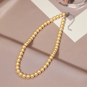 Detailed view of champagne gold pearl necklace with adjustable silver lobster clasp