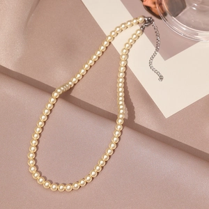 Detailed view of elegant cream pearl necklace with silver adjustable chain and lobster clasp