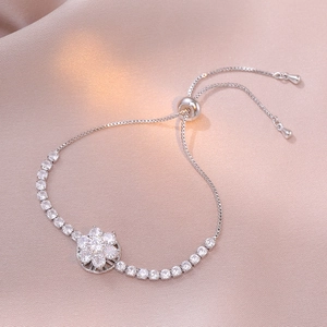 Silver flower slider bracelet with micro-p镶 inlaid zircons on a soft silk background