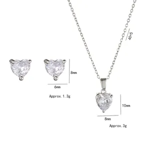 Silver heart necklace and earring set with cubic zirconia and dimension details