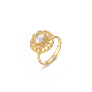 Macro detail of golden spinning flower ring with iridescent opal and sparkling zircon