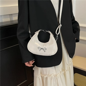 Elegant white crescent shoulder bag with silver bow and leather texture for women