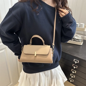 Minimalist light camel small square bag with flap closure and gold metal buckle detail