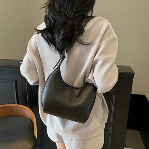 Minimalist black matte faux leather crescent underarm bag with adjustable shoulder strap