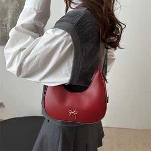Minimalist red crescent shoulder bag with silver metallic bow detail for women