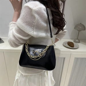 French style black glossy leather shoulder bag with gold bow and elegant chain strap