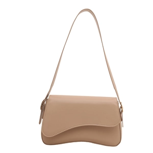 Minimalist beige PU leather underarm saddle bag with modern curved silhouette and long strap