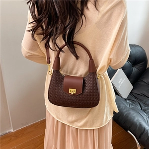 French crescent underarm bag in dark brown textured leather with golden metal clasp