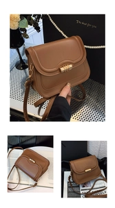 Detail of vintage brown saddle bag featuring a distinctive golden cylinder twist lock