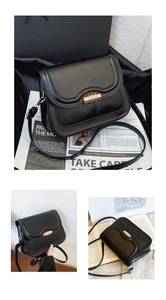 Detail of minimalist black faux leather crossbody bag with golden cylindrical lock