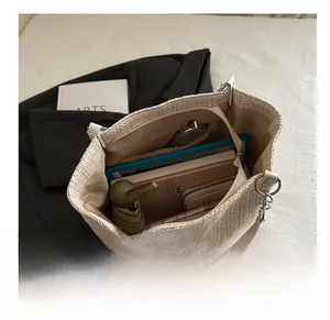 Top view of beige woven tote bag interior showing large capacity with inner zipper pocket