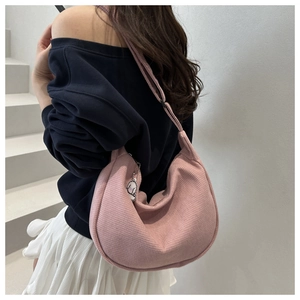 Pink waffle texture crescent shoulder bag with cute white dog charm shown on model