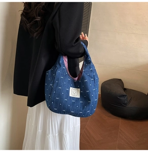 Detail der Jeans-Handtasche mit Bären-Patch, Herzmuster und rotem Streifenfutter
