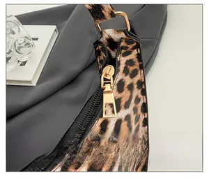 Detailed macro shot of smooth gold metal zipper and leather texture on leopard print bag