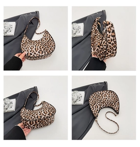Detail view of leopard print hobo bag showing crescent shape and gold zipper hardware