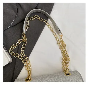 Detail of sequin shoulder bag with golden chain and comfortable leather strap