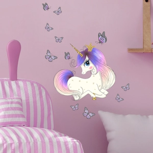 Detailed view of glowing unicorn and butterfly wall stickers in a cozy pink bedroom